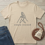 Simply Rescued T-shirt in light tan with a black line art paw and hand forming a heart.