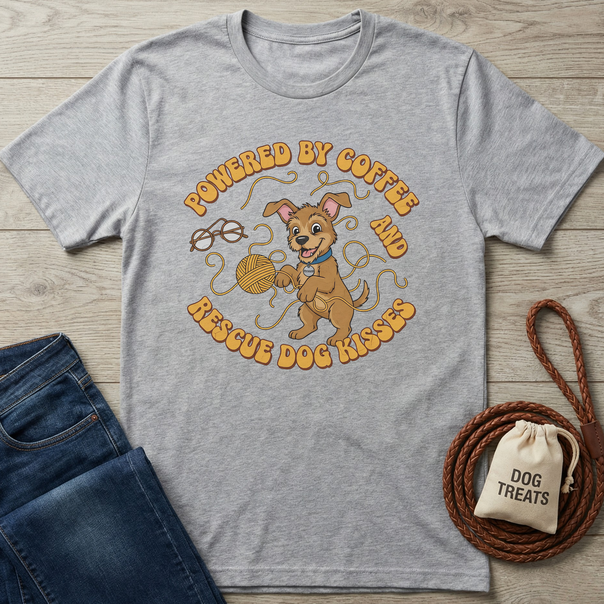 Gray cotton t-shirt with "Powered by Coffee & Rescue Dog Kisses" text and a playful brown dog graphic.