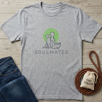 Light grey Gildan Softstyle® t-shirt with "Soulmates" dog and person graphic, beside jeans and dog treats.
