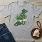 Light gray heather t-shirt with a green dog silhouette filled with colorful flowers and "Bloom Where You Are Rescued" banner.