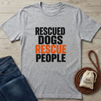Light grey Gildan Softstyle® t-shirt with "RESCUED DOGS RESCUE PEOPLE" text, alongside jeans and dog accessories.