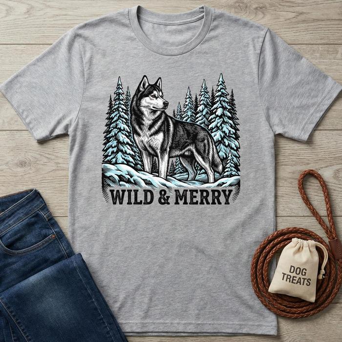 Gray "Wild & Merry" t-shirt with a husky in a snowy forest design, next to jeans and dog treats.