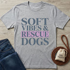 Light grey Gildan Softstyle t-shirt with "Soft Vibes & Rescue Dogs" text, styled with jeans and dog accessories.