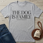 Gray "The Dog is Family" t-shirt, dark wash jeans, brown leash, and a "Dog Treats" pouch on wood.