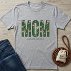 Light grey Gildan Softstyle® t-shirt with "MOM nurtured with love" in floral green text.