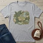 Heather gray t-shirt with a sleeping dog by a waterfall and ferns, "The Quiet of the Pack" text.