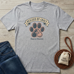 Heather gray t-shirt with "Rescued By Grace" banner, paw print with cross, and "Paws & Prayers" text.