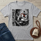Gray Unleased T-shirt with a jumping dog in an orange harness and forest graphic.