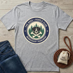 Gray "The Dogs > People Club" t-shirt with a dog, bones, and trees graphic.