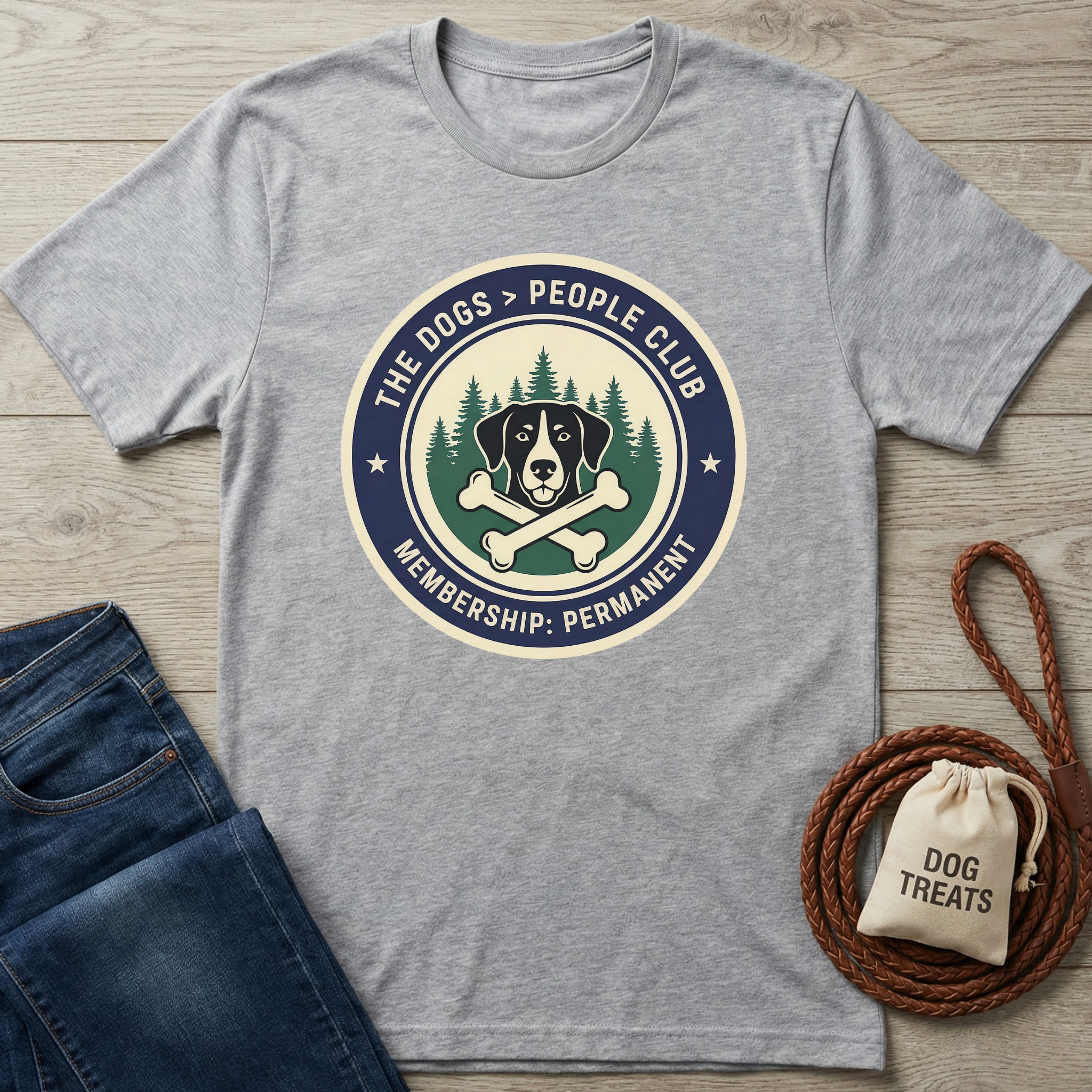 Gray "The Dogs > People Club" t-shirt with a dog, bones, and trees graphic.