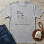 Heather gray cotton t-shirt with "PRAYERS & PAWS" text and praying hands with a dog paw design.