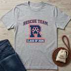 Light grey Gildan Softstyle® t-shirt with "RESCUE TEAM" and "CLASS OF 2026" in red and blue, featuring a paw print.