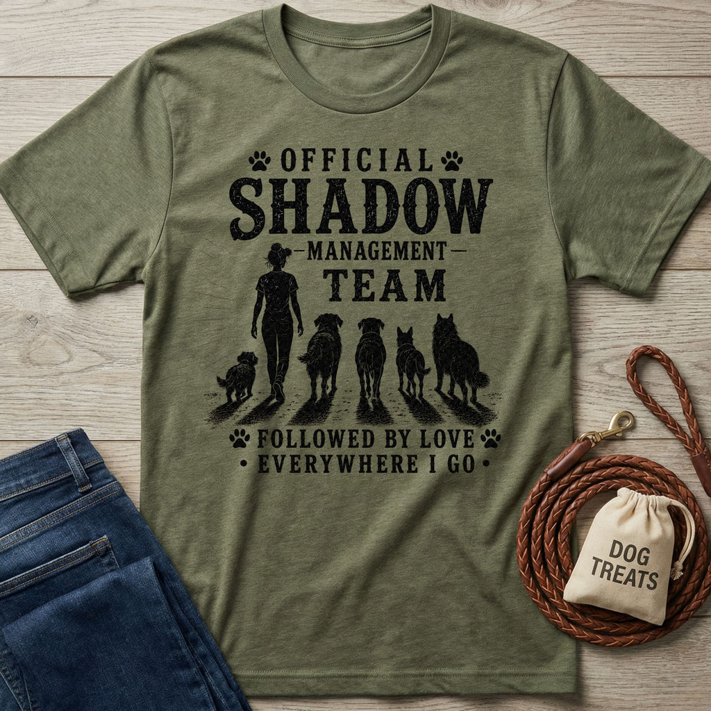 Olive green heather t-shirt with "Official Shadow Management Team" graphic featuring a person and five dogs.