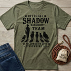 Olive green heather t-shirt with "Official Shadow Management Team" graphic featuring a person and five dogs.