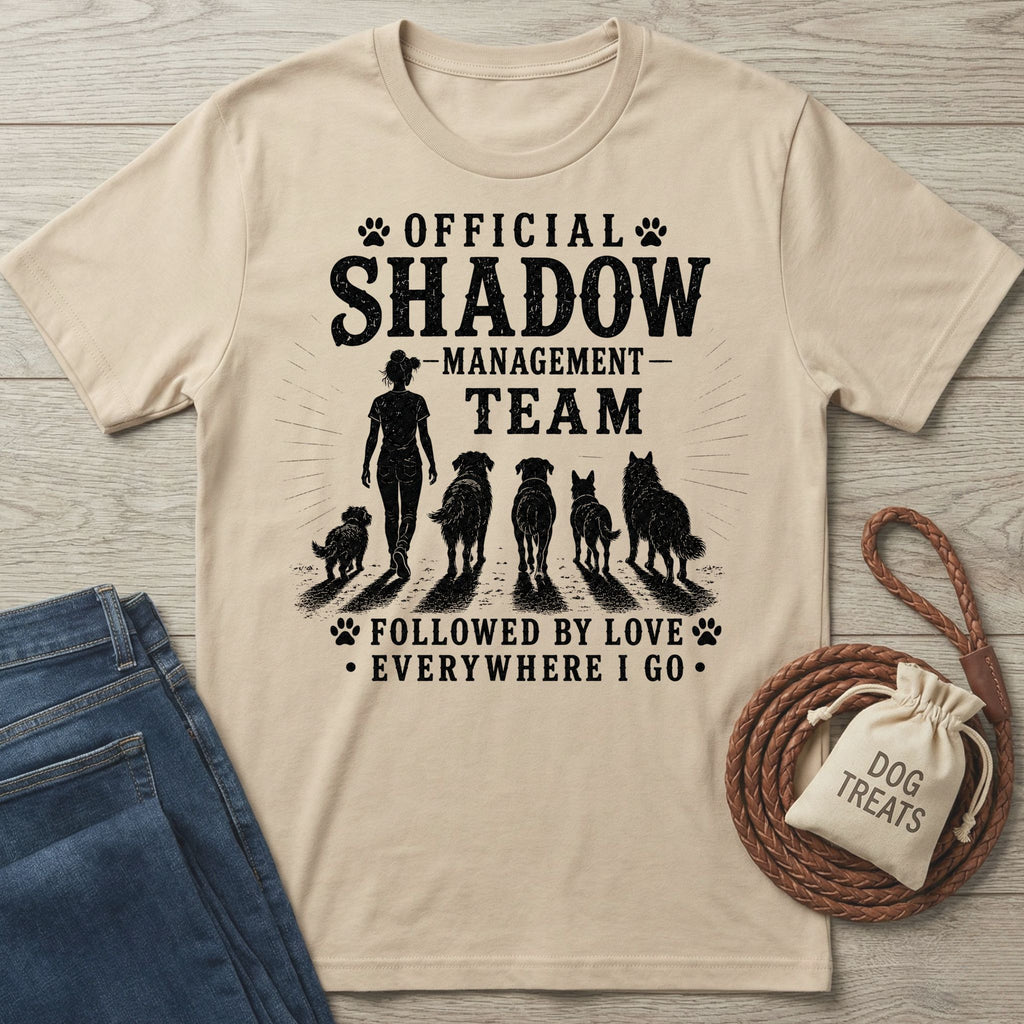 Beige cotton t-shirt with "Official Shadow Management Team" graphic featuring a person and five dogs.