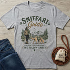 Heather gray crewneck t-shirt featuring a graphic of a hiker and dog with the text Sniffari Guide on a wooden background.