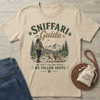 Beige crewneck t-shirt featuring a hiker and dog graphic with the text Sniffari Guide and We Follow Sniffs.