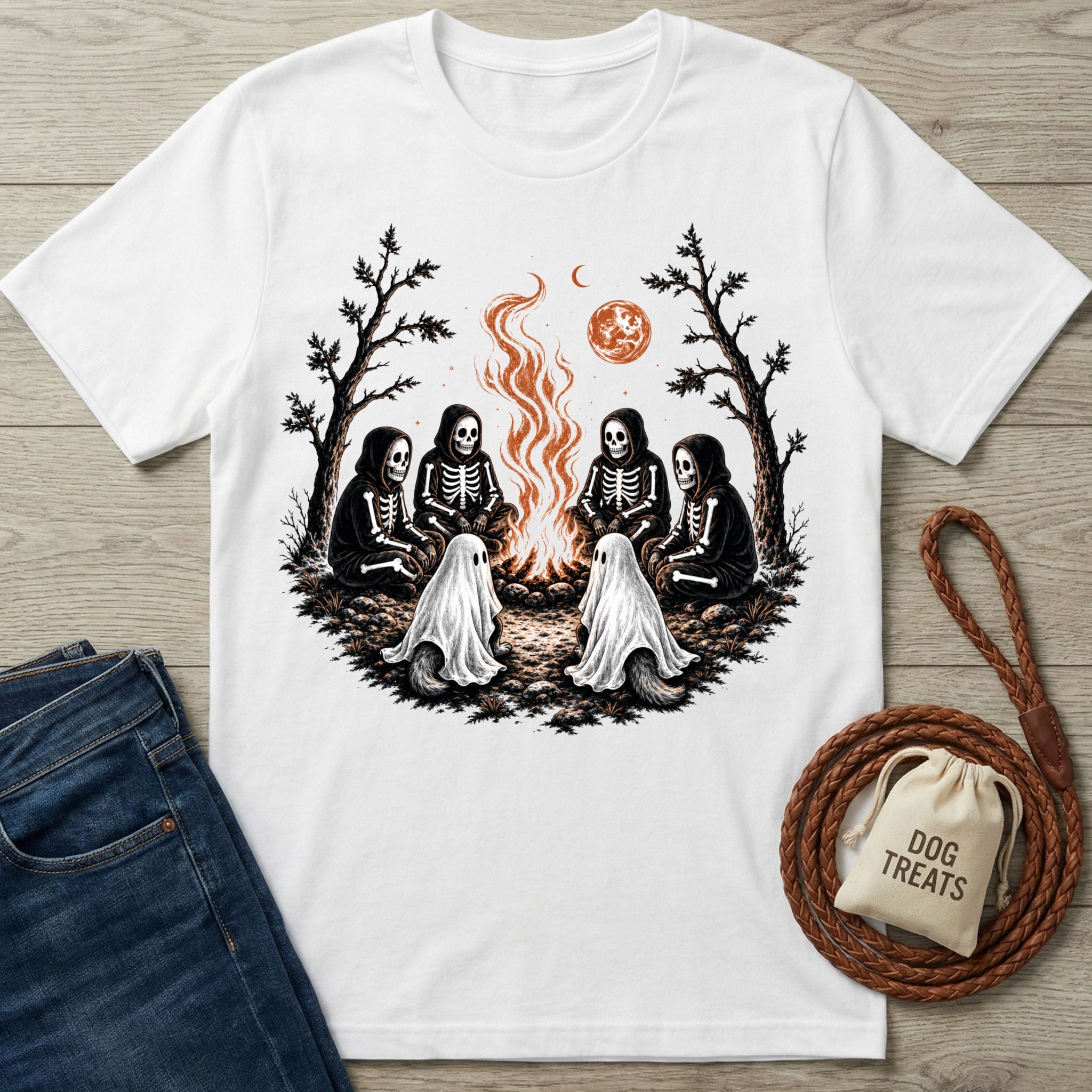 White crewneck t-shirt featuring skeletons and ghost dogs sitting around a campfire under a blood moon.