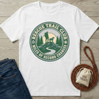 White Rescue Trail Club T-shirt with a green and blue graphic of a hiker, dog, mountains, and trees.