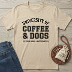 Tan Gildan Softstyle® t-shirt with "University of Coffee & Dogs" graphic, next to jeans and dog treats.