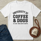 White Gildan Softstyle® t-shirt with "University of Coffee & Dogs" graphic, next to jeans and dog treats.