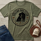 Olive green crewneck t-shirt featuring a vintage-style circular Velcro Dog Club graphic with a dog sitting by a person's leg.