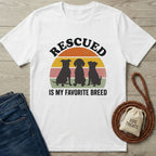 White Gildan Softstyle t-shirt with "RESCUED IS MY FAVORITE BREED" text and three dog silhouettes.