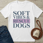 White Gildan Softstyle t-shirt with "Soft Vibes & Rescue Dogs" text, next to jeans and dog leash.