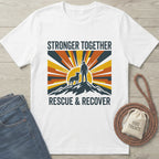 White Gildan Softstyle® t-shirt with "Stronger Together Rescue & Recover" graphic featuring a person and dog on a mountain.