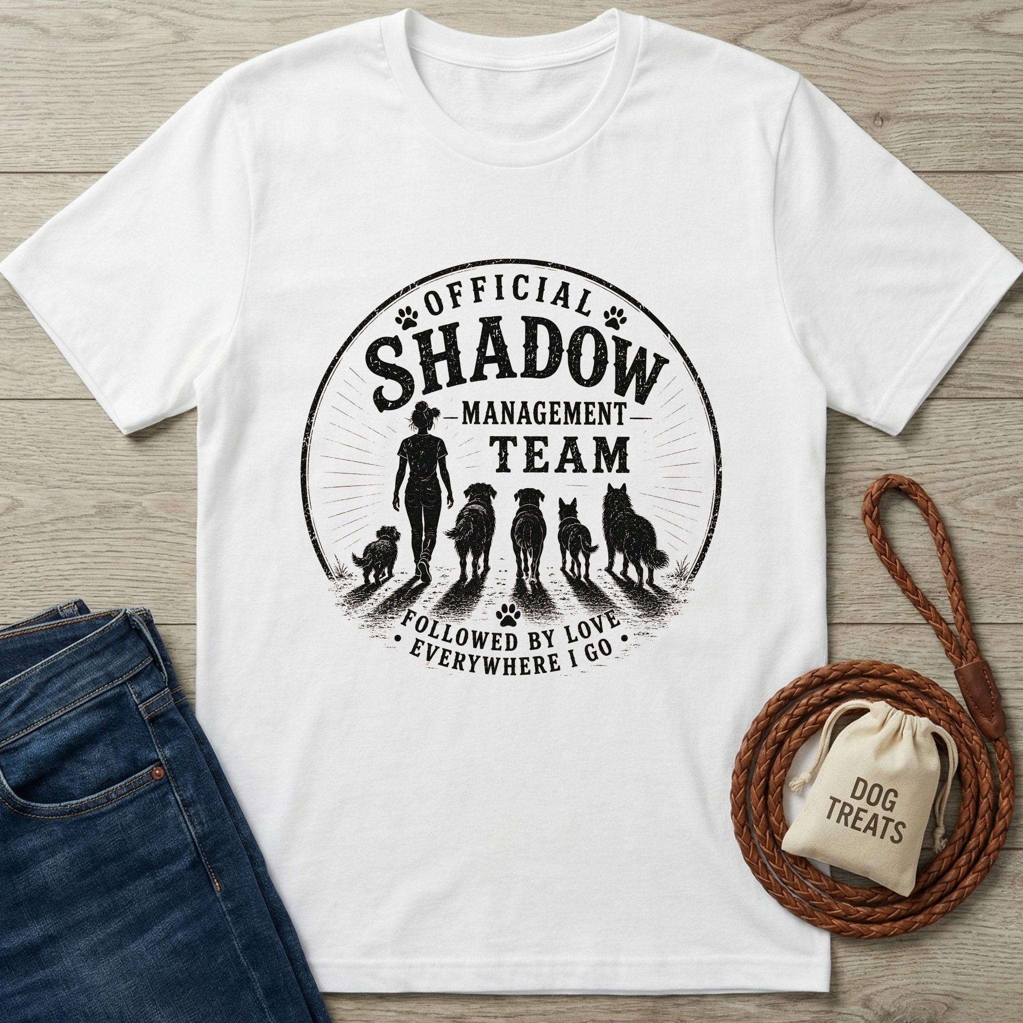 White cotton t-shirt with "Official Shadow Management Team" graphic featuring a person and five dogs.