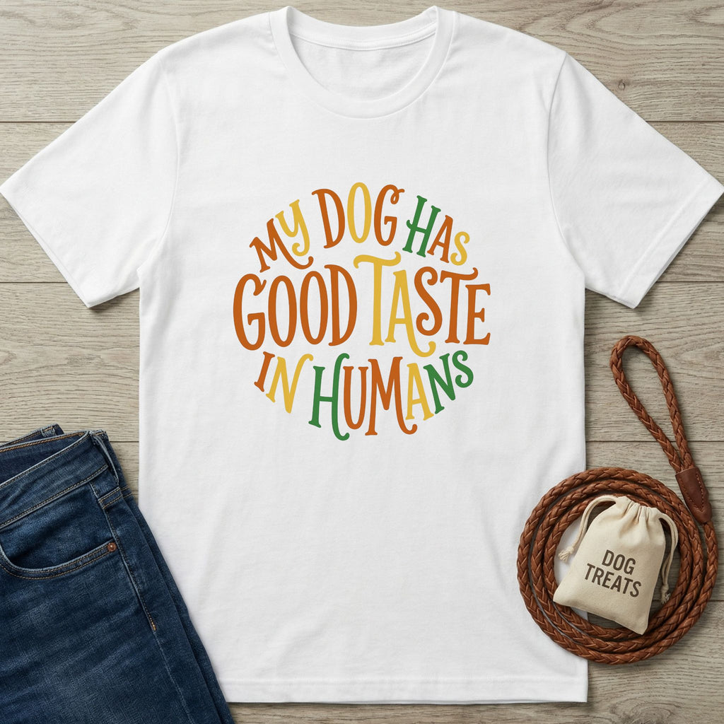 White Gildan Softstyle t-shirt with "My Dog Has Good Taste In Humans" in orange, yellow, and green.