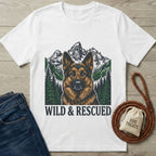 White Gildan Softstyle® t-shirt with a German Shepherd, mountains, and "WILD & RESCUED" graphic.
