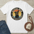 White cotton "Rescue Mom" t-shirt with a vintage-style graphic of a black dog and colorful stripes.
