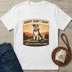 White Gildan Softstyle t-shirt with "Adopt Don't Shop" graphic featuring a happy mixed-breed dog.
