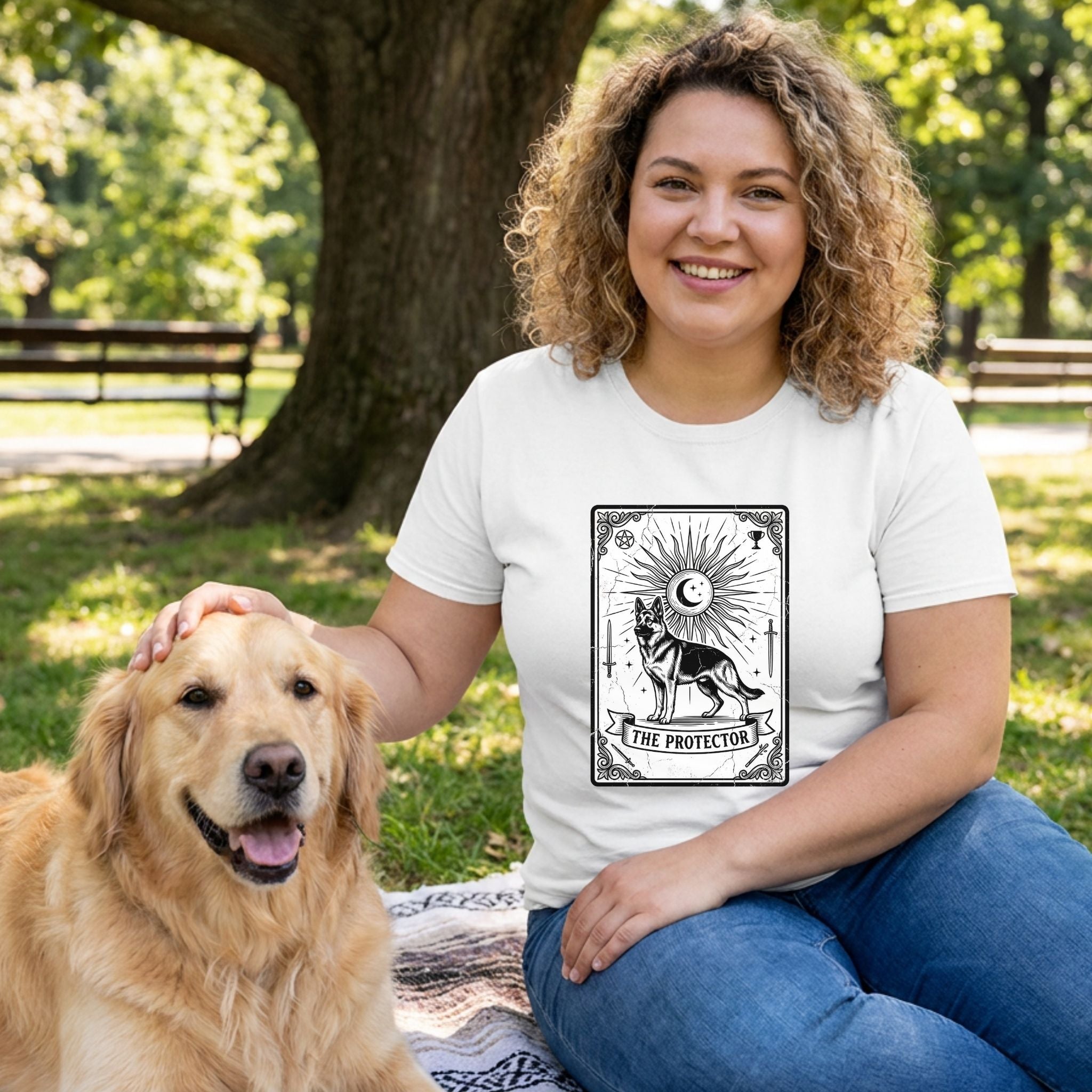 Woman in white "The Protector" Tarot Card T-Shirt with a German Shepherd design, petting a golden retriever.