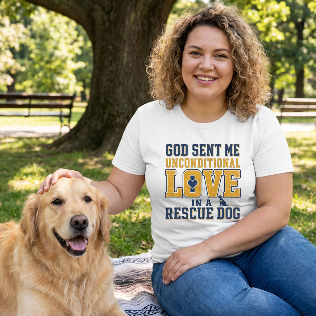 Woman in white "God Sent Me Unconditional Love In A Rescue Dog" tee petting a golden retriever in a park.