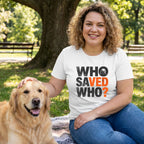 Woman in white Gildan Softstyle® tee with "WHO SAVED WHO?" graphic, petting a golden retriever in a park.