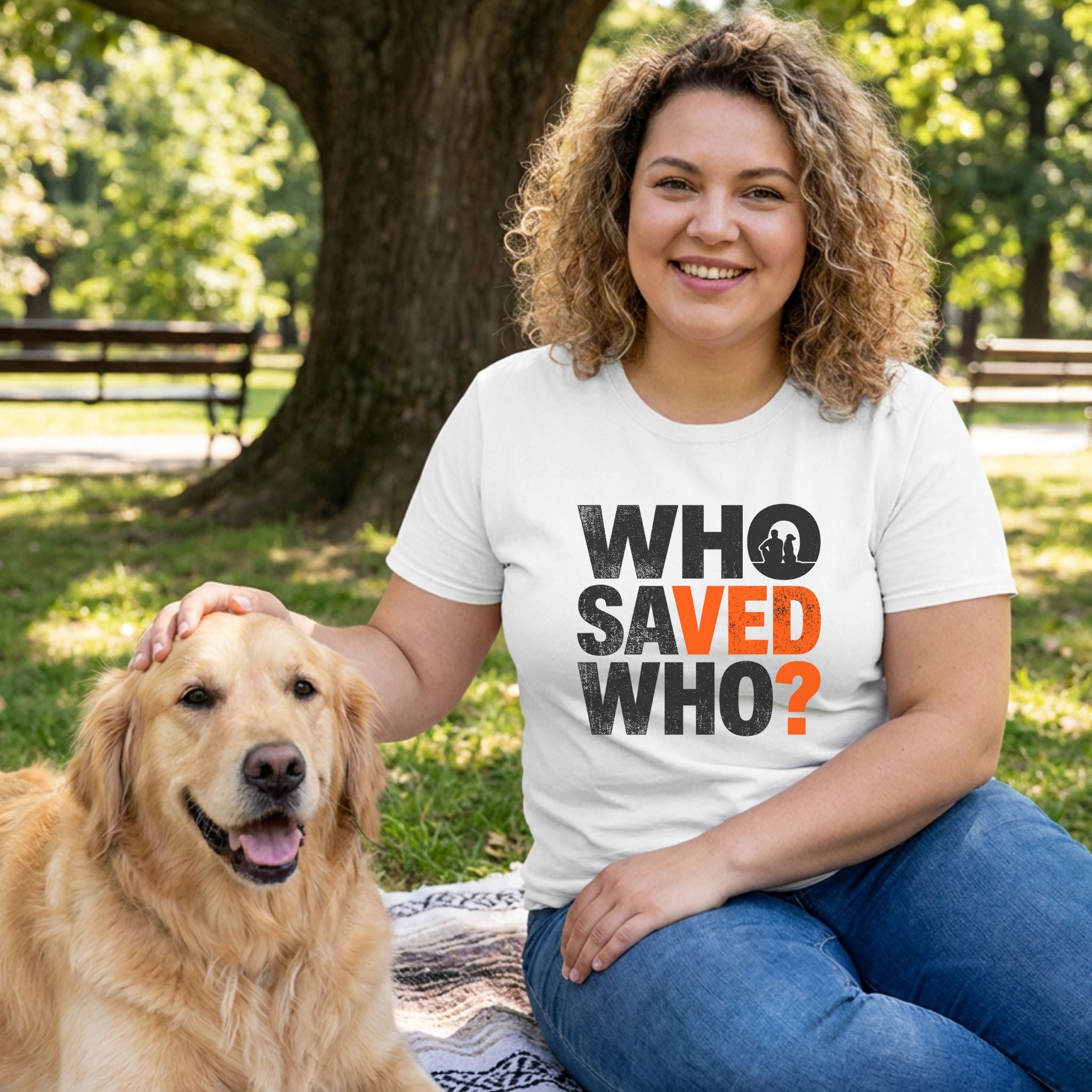 Woman in white Gildan Softstyle® tee with "WHO SAVED WHO?" graphic, petting a golden retriever in a park.