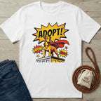White Gildan Softstyle® t-shirt with a comic-style "ADOPT!" superhero dog graphic.