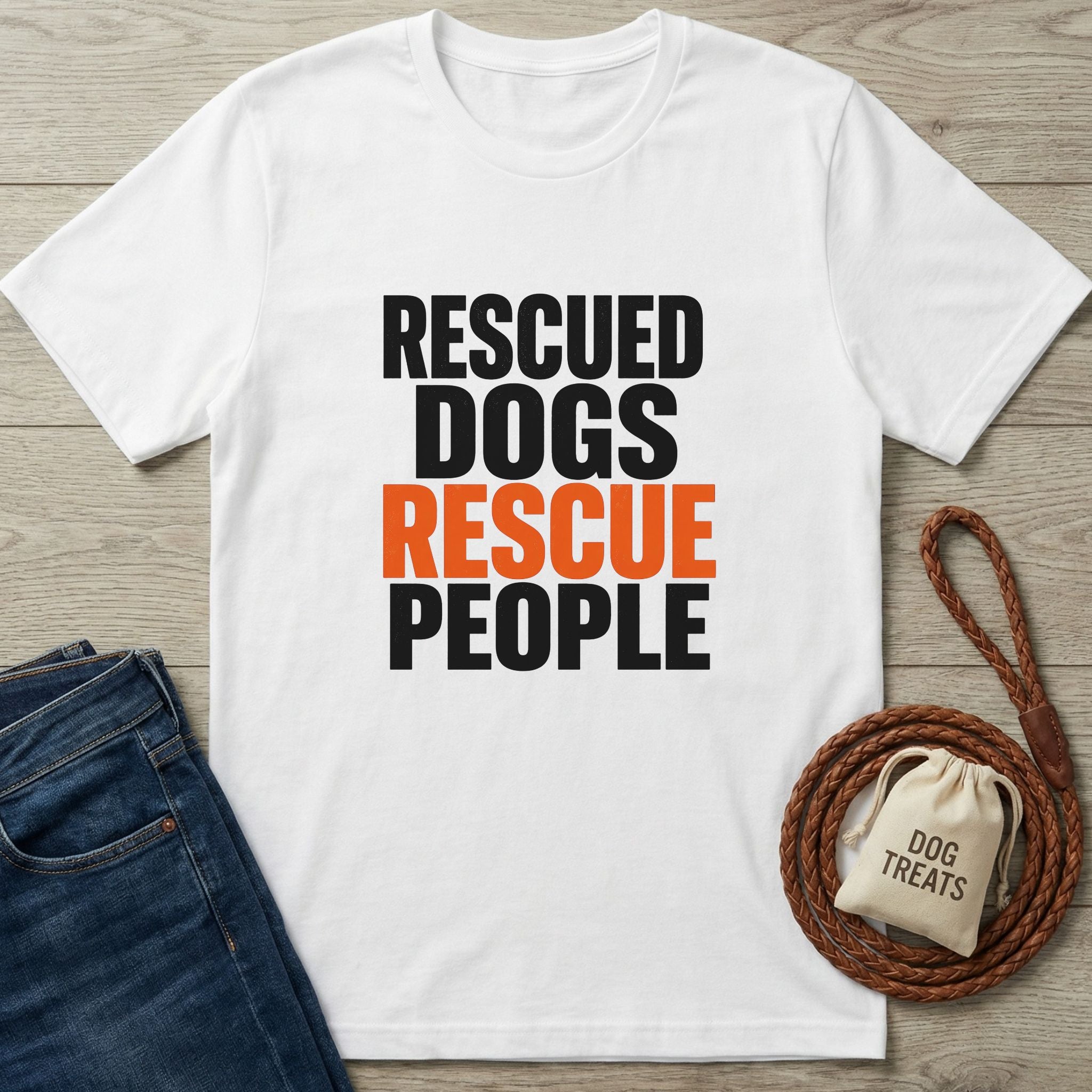 White Gildan Softstyle® t-shirt with "RESCUED DOGS RESCUE PEOPLE" text, dark jeans, and a dog leash.
