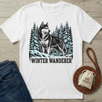 White crewneck t-shirt featuring a graphic of a husky in a snowy pine forest with the text Winter Wanderer.